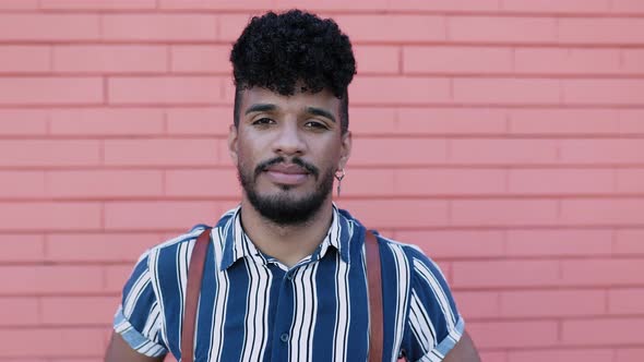 Serious Young Hispanic Latin Man Looking at Camera Outdoor