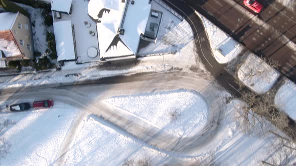 Top down drone shot of snow covered rooftops and roads in Orebro city, Sweden