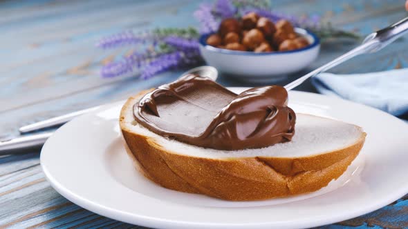 Spreading hazelnut cream on bread, chocolate nut butter