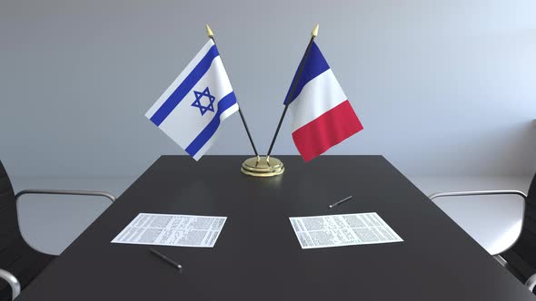 Flags of Israel and France and Papers