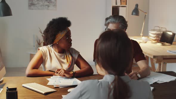 Business Team of Mixed-Age Professionals Having Meeting in Office