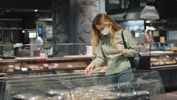 Young Caucasian Millennial Girl Consumer Shopper Woman Wears Medical Protective Mask Shopping in