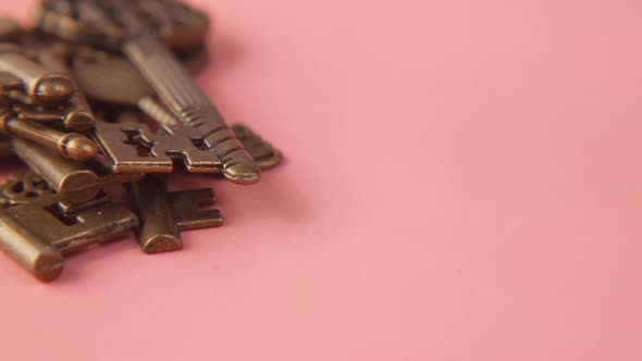 Close Up of Old Keys on Pink Background
