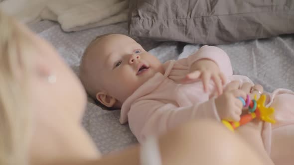 Mum Looking at Playful Baby Daughter