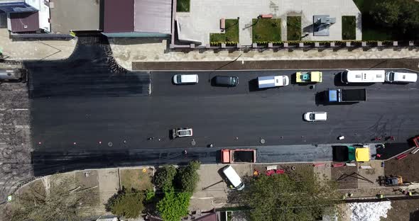 Aerial Top Down View of Asphalting Construction Works with Commercial Repair Equipment Road Roller