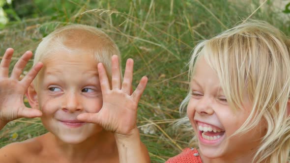 Funny Dirty Faces Children Blonde Brother and Sister Make Faces Laugh Smile and Have Fun in Village