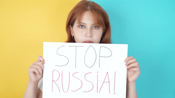 A Beautiful Redhaired Ukrainian Woman Says Stop Russia in the Colors of Ukraine