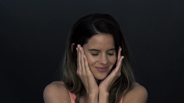 Woman holding hands on face, smiling