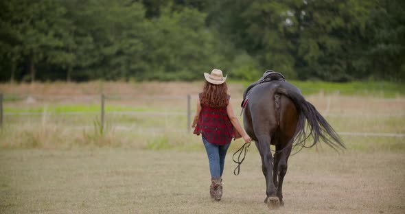 Woman Riding Horse on Farm. Recreation - Woman Walking with Horse