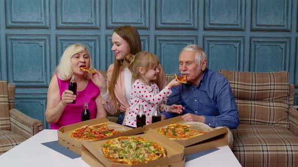 Happy Family Having Lunch Party Feed Each Other with Pizza Laughing Enjoying Meal Together at Home