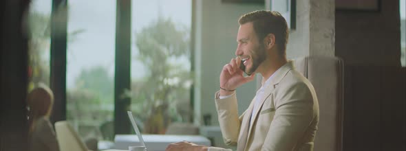 Smiling handsome businessman having call