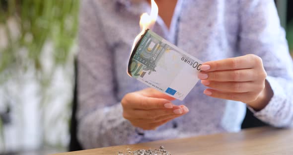 A Woman in the Office Burns 100 Euros Shallow Focus