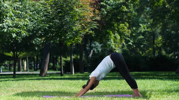 Young Woman Doing Yoga Pose on Park