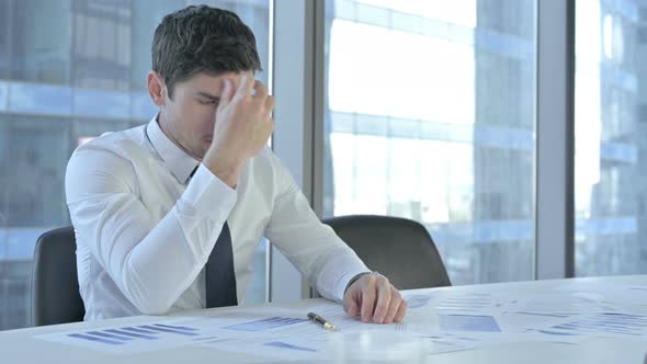 Ambitious Businessman Thinking and Working on Project Documents