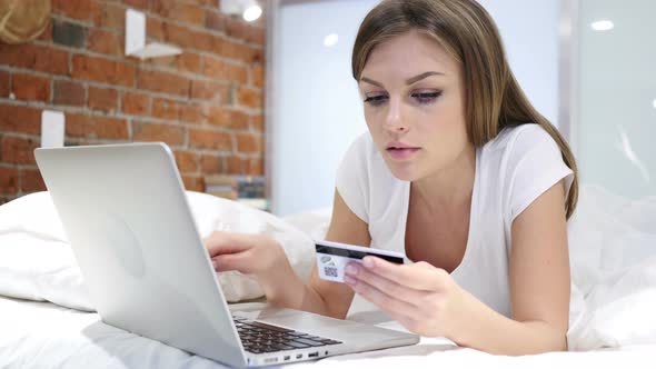 Online Shopping by Woman in Bed, Payment by Credit Card