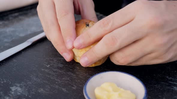 Male Baker Hands Breaking Homemade Bread Into Two Parts