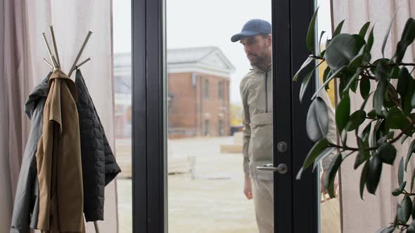 Delivery Man Giving Paper Bag to Customer at Home