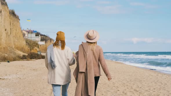 Beautiful Girls Walk Near the Sea