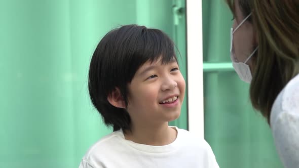 Asian Mother Wear Safety Mask Talking With Her Son