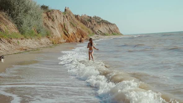 Slow Motion of Happy Joyful Woman with Perfect Slim Fitness Body Wearing in Bikini and Enjoying Wind