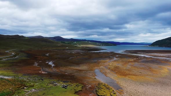 Push-in drone shot of dried up scottish lake landscape. Aerial video shot in Scotland, highland land