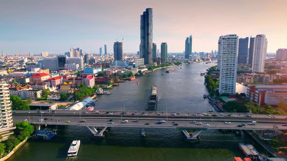 4K : Drones fly over the Chao Phraya River, buildings and business districts in Bangkok