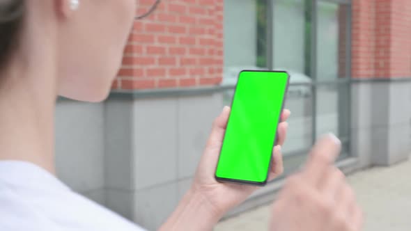 Walking Woman Browsing Internet on Smartphone with Green Chroma Screen