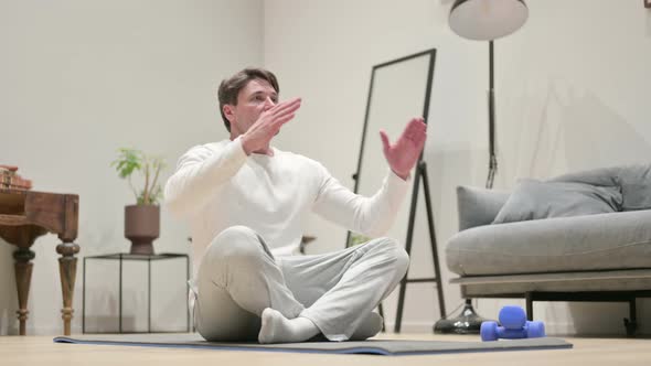 Portrait of Hands of Man Meditating on Yoga Mat at Home