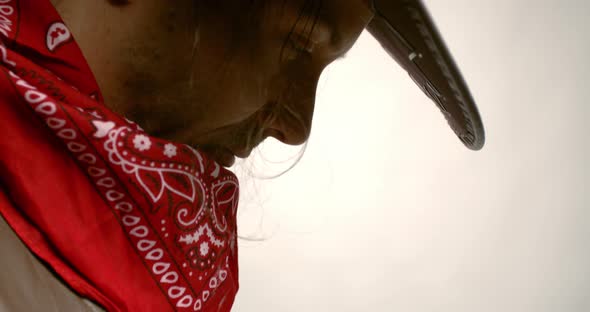 Profile footage of a cowboy with red bandana and a leather hat, 4k