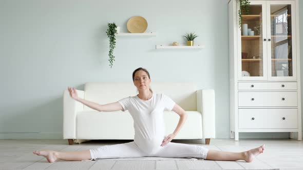 Pregnant Woman Does Side Bends Training on Floor at Home