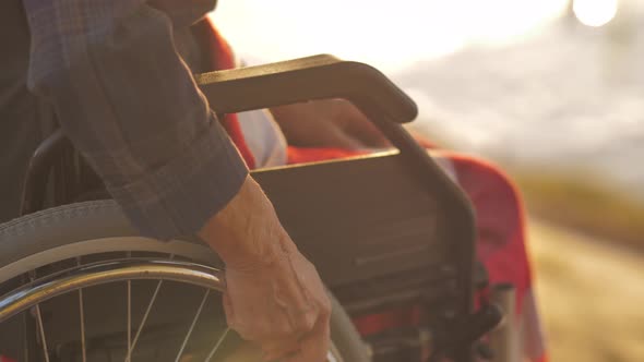 Hand Takes the Wheel of a Wheelchair