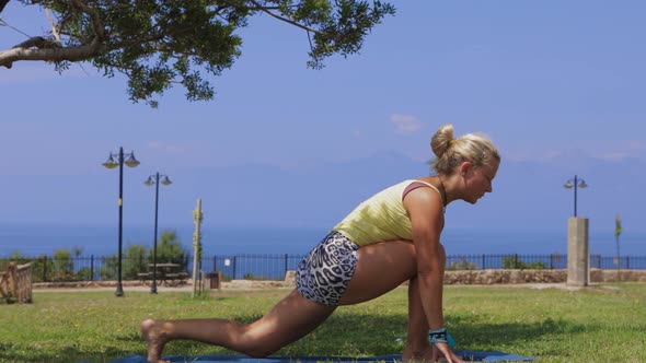 An Adult Woman Doing Yoga on Nature By the Sea