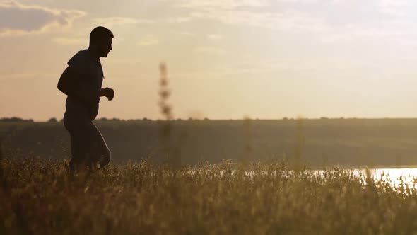 Silhouette of Man Jogging at Sunset