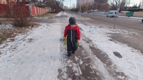 Boy Walking On The Sidewalk In Winter Slow Motion