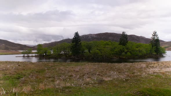 Cinematic timelapse of scottish lake with misty clouds in background