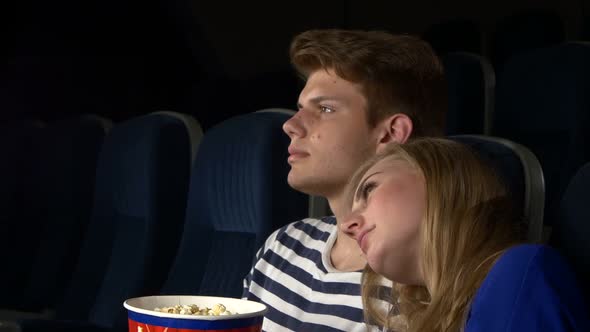 Couple Feeding Each Other at the Cinema