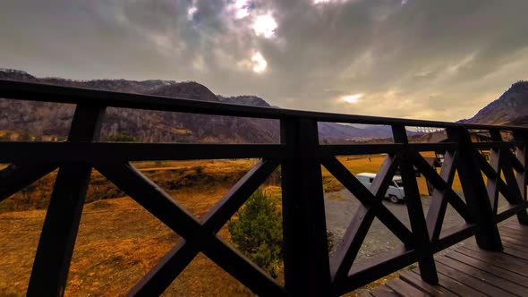 Timelapse of Wooden Fence on High Terrace at Mountain Landscape with Clouds