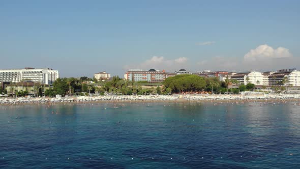 People Bathing in the Sun, Swimming on the Beach. Aerial View of Tourists on the Sand Beach.