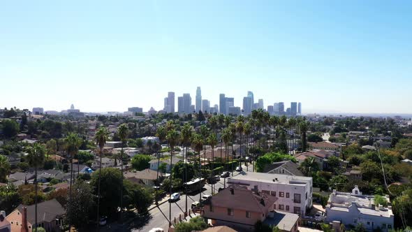 Beautiful drone shot flys up to show Los Angeles, California's Echo Park neighborhood, covered in pa