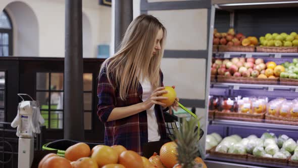 Woman Looking for Fruits in Supermarket Put It Into Basket