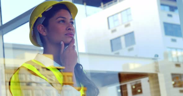 engineer looking outside window at building