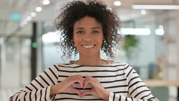 African Woman Showing Heart Sign with Hand