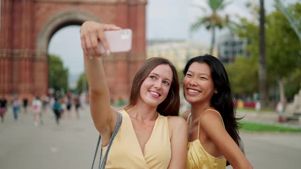 Smiling Multiracial Girlfriends Tourists Posing for Selfie Picture Against Historic Building in City