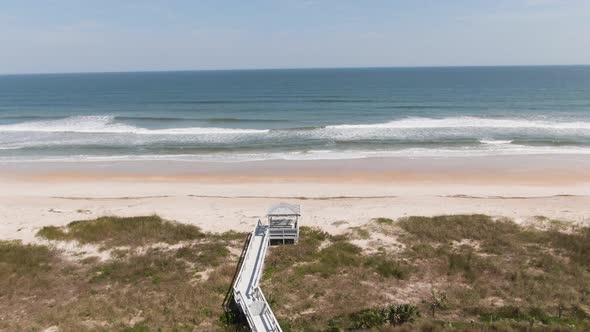 Push in over beach to waves crashing onto the beach from the ocean in Ponte Vedra Florida