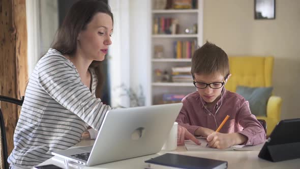 Mom Helps Son Do Homework on Distant Learning During Quarantine