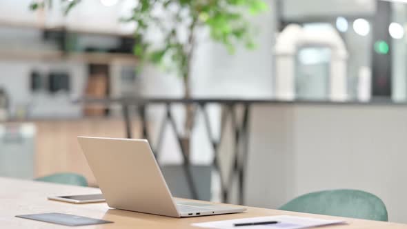 Young African Woman Coming and Starting Work on Laptop