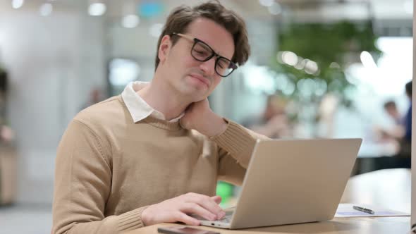 Man Having Neck Pain While Working on Laptop