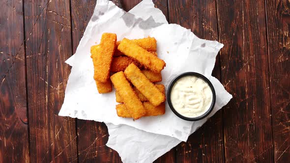 Pile of Golden Fried Fish Fingers with White Garlic Sauce