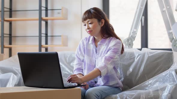 Woman with Laptop Moving Into New Home