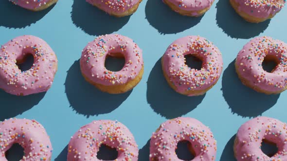 Video of donuts with icing on blue background